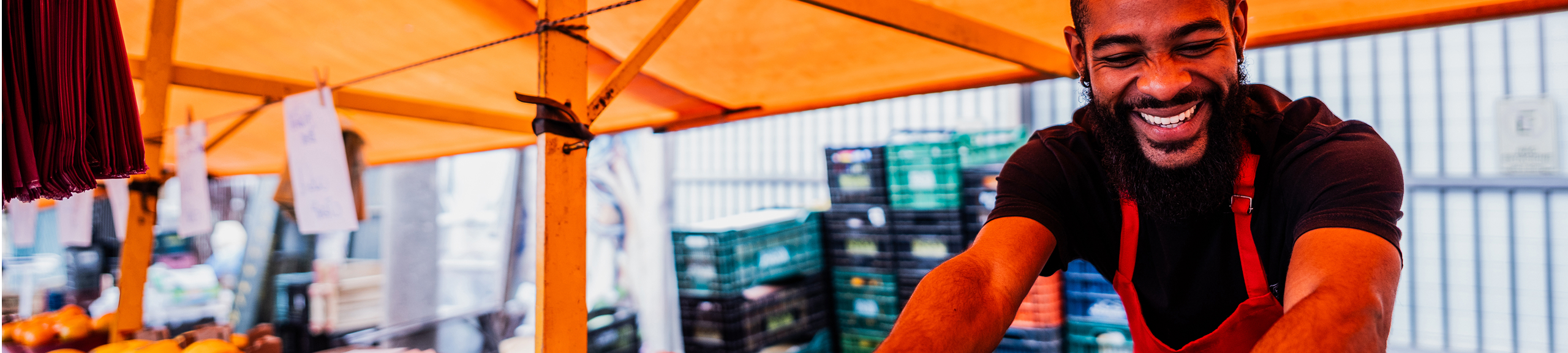 Salesman organizing fruits at a street market
