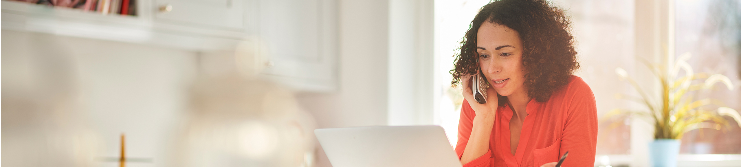 woman on computer and phone